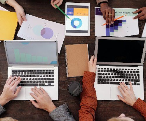 A top-down shot of people working at a table.
